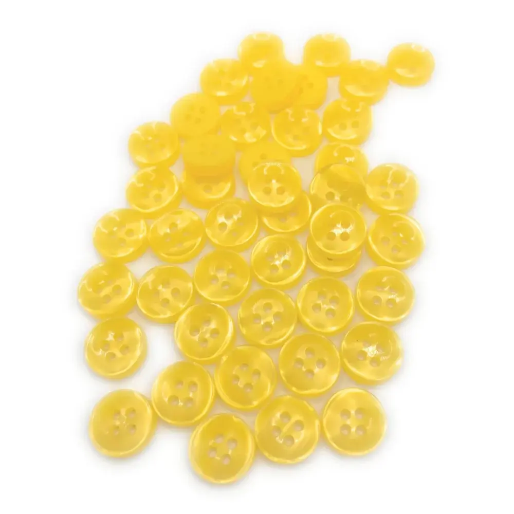 Pile of yellow four-hole buttons.