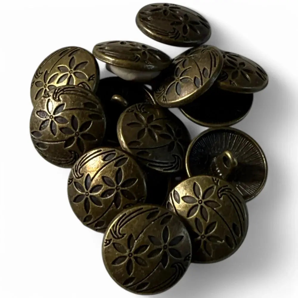 Pile of bronze flower-patterned buttons.