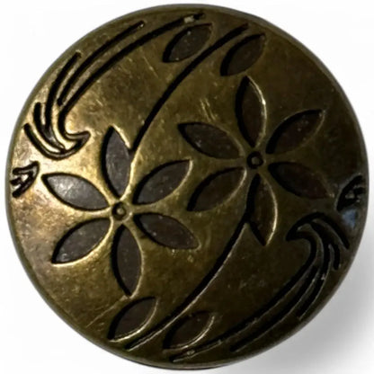 Circular bronze-toned button with floral design.