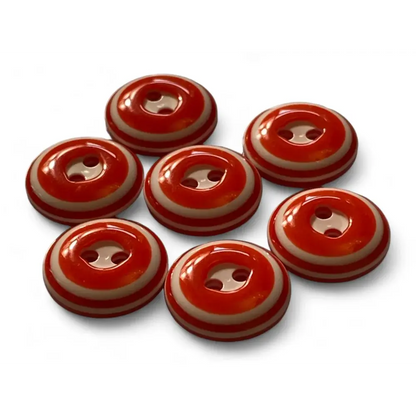 Seven red and beige striped buttons.