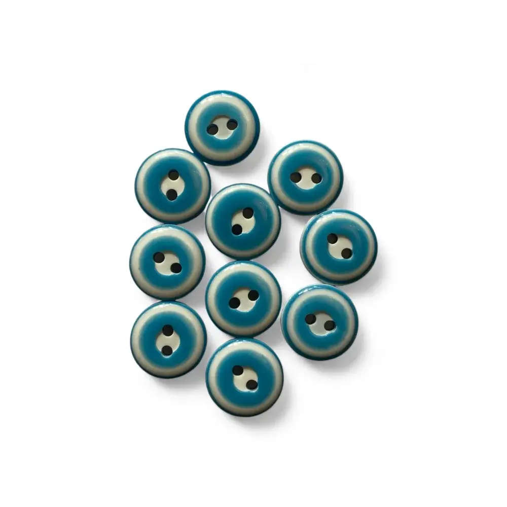 Collection of two-hole teal and white buttons.