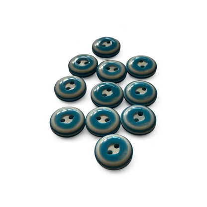 Teal and beige two-hole buttons.