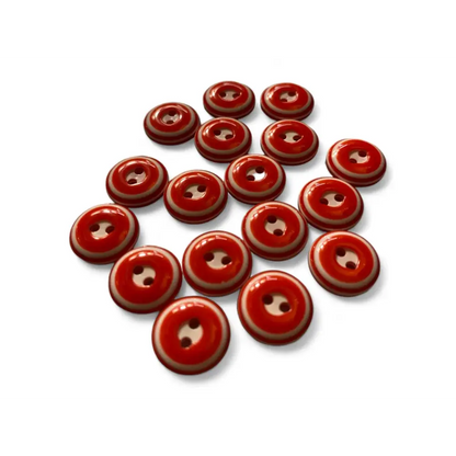 Red and tan two-hole buttons.