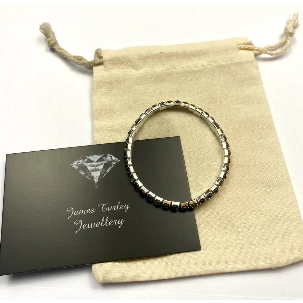 Silver bracelet with dark stones.