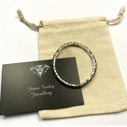 Silver bracelet with dark stones.